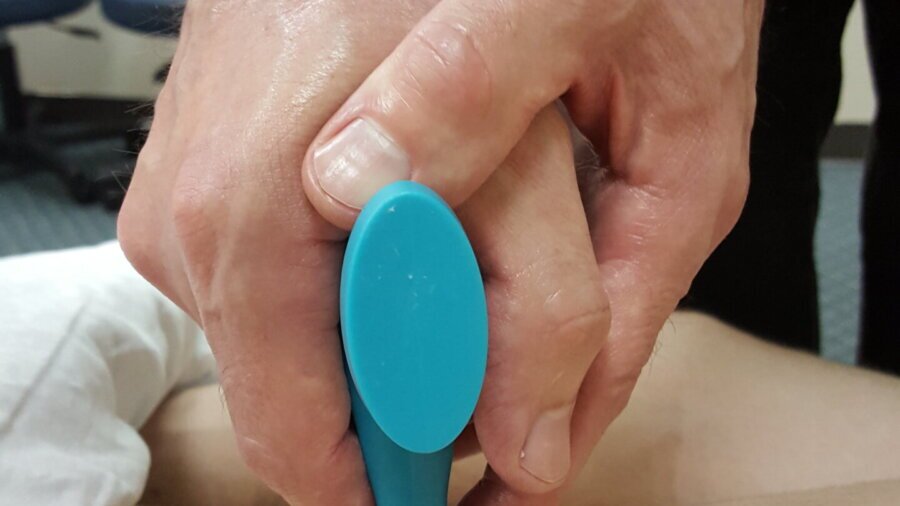 Two Hands on a Massage Tool